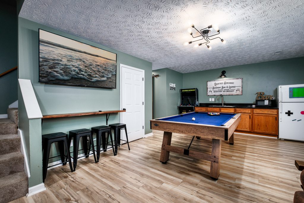 Game room with pool table and wet bar at a vacation rental in the Smoky Mountains.