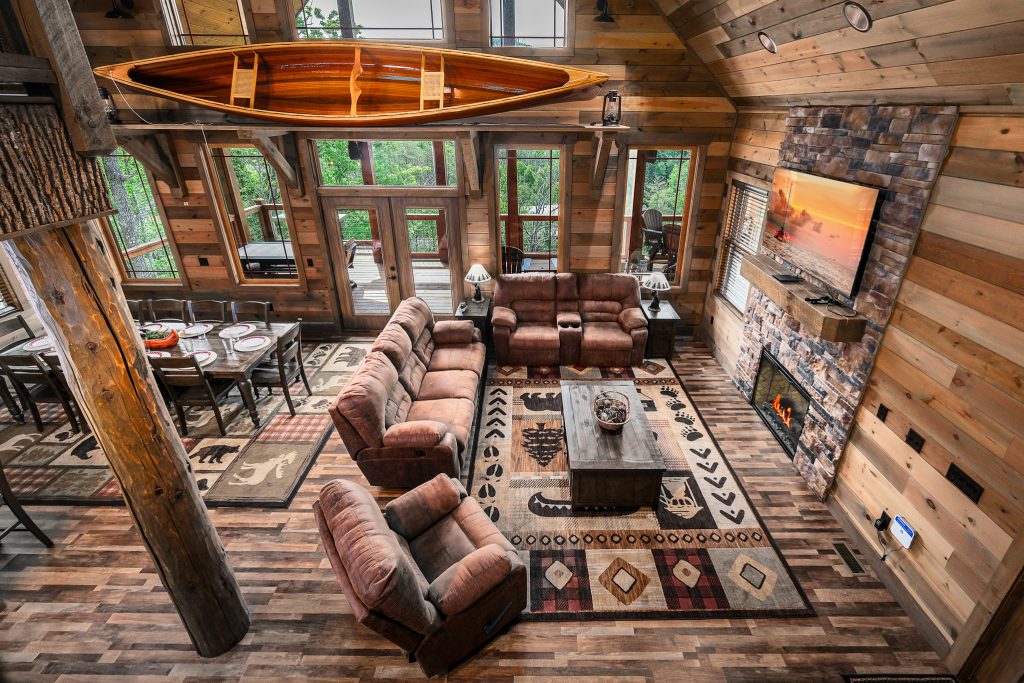 Two-story log cabin living room from loft at a vacation rental in the Smoky Mountains.