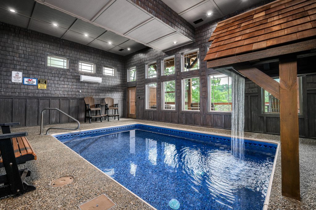 Indoor pool and waterfall feature at a vacation rental in the Smoky Mountains.