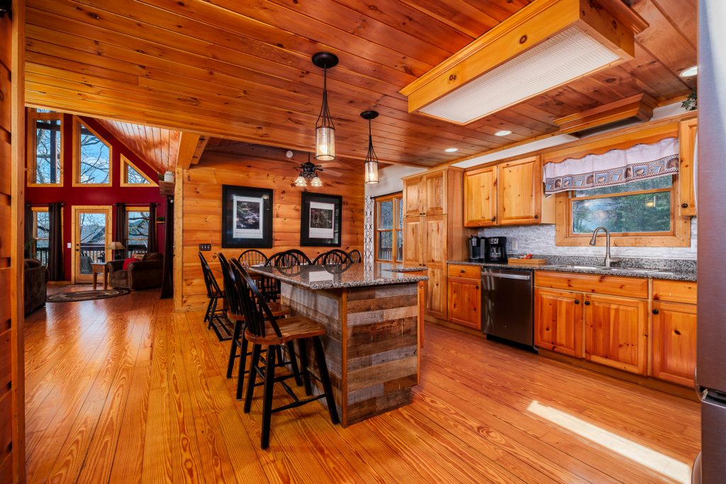 Log cabin kitchen and dining area at a vacation rental in the Smoky Mountains.