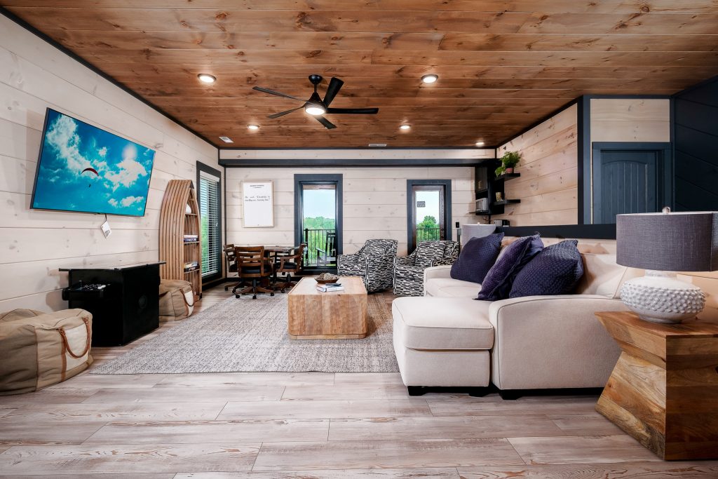 Modern cabin living room with sectional at a vacation rental in Sevierville, Tennessee.
