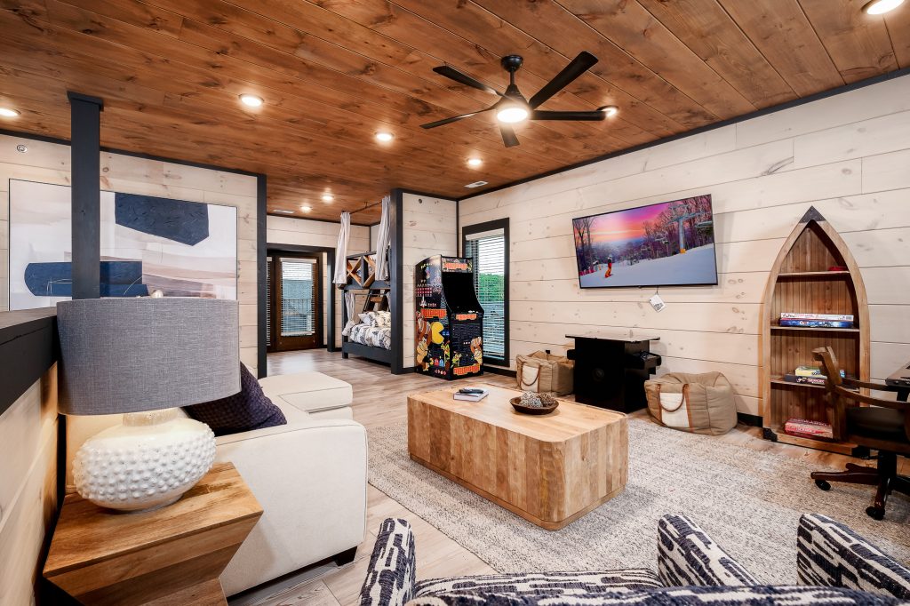 Modern cabin family room and arcade games at a vacation rental in Sevierville, Tennessee.