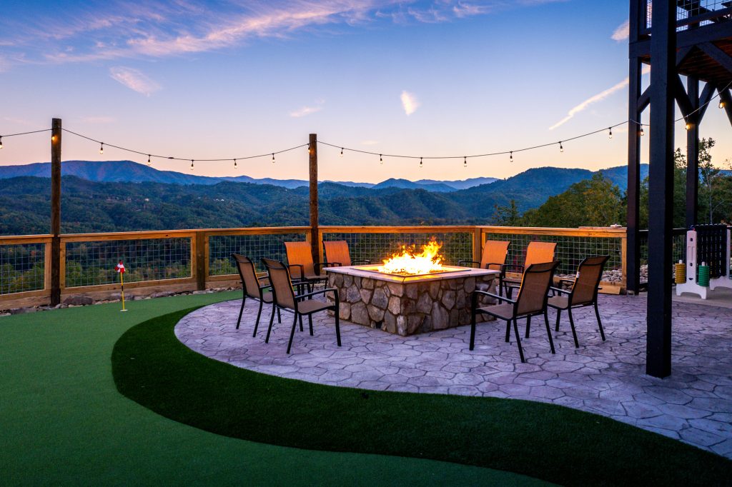 Mountain-view fire pit patio at twilight at a vacation rental in Wears Valley in the Smoky Mountains.