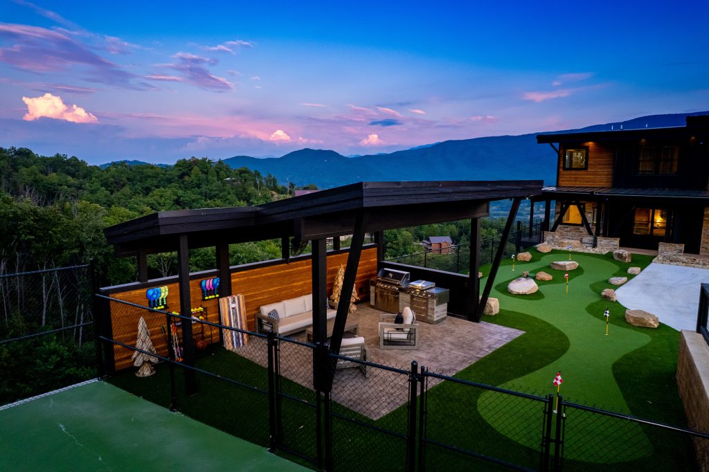 Covered patio overlooking putting green and mountains at a vacation rental in Wears Valley in the Smoky Mountains.