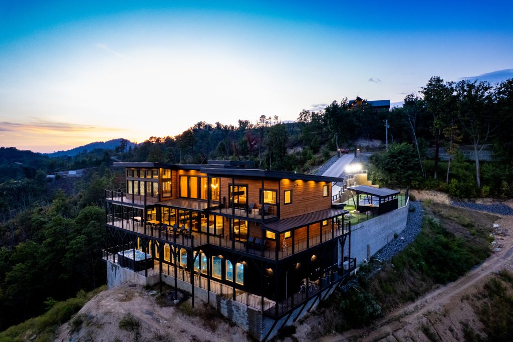 Luxury cabin aerial above mountain slope at a vacation rental in Wears Valley in the Smoky Mountains.