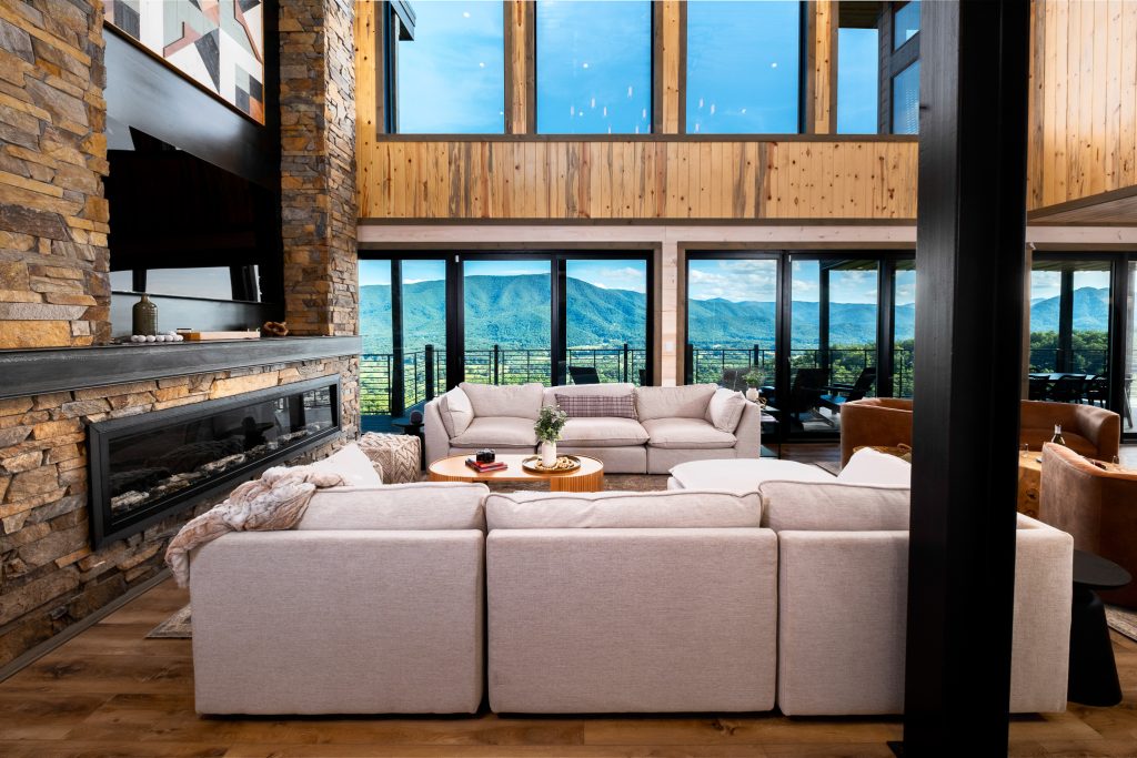 Great room with floor-to-ceiling mountain windows at a vacation rental in Wears Valley in the Smoky Mountains.