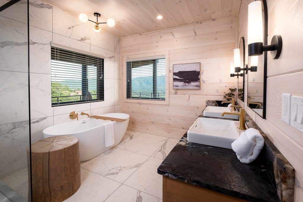Spa bathroom with soaking tub and dual vanities at a vacation rental in Wears Valley in the Smoky Mountains.