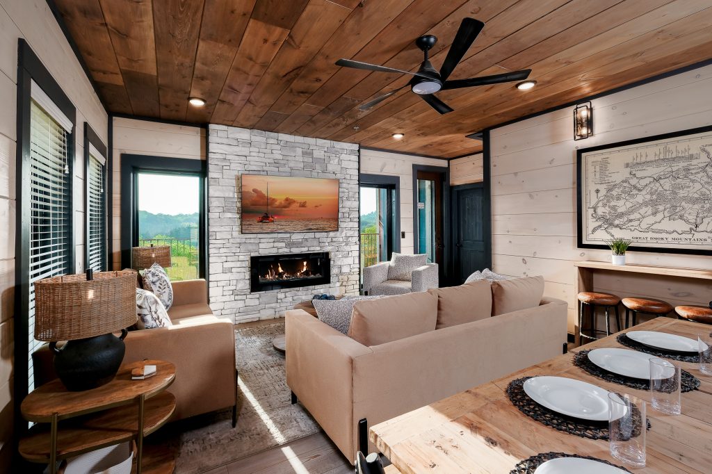 Modern living room with fireplace and map art at a vacation rental in Wears Valley in the Smoky Mountains.