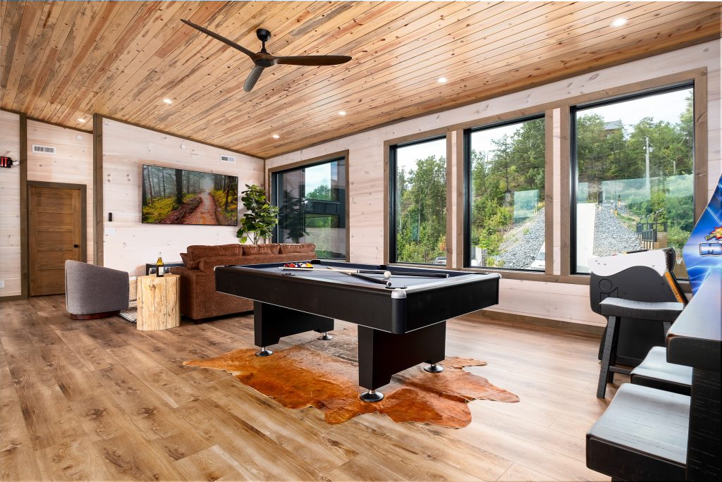 Game room with pool table and picture windows at a vacation rental in Wears Valley in the Smoky Mountains.