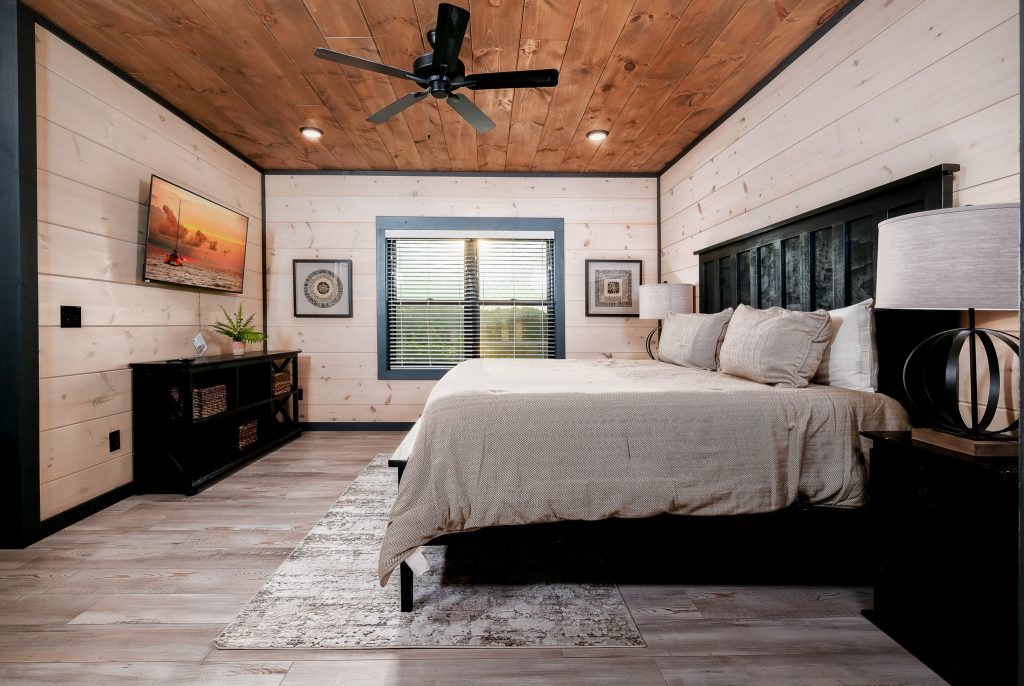 Modern king bedroom with fireplace at a vacation rental in Wears Valley in the Smoky Mountains.