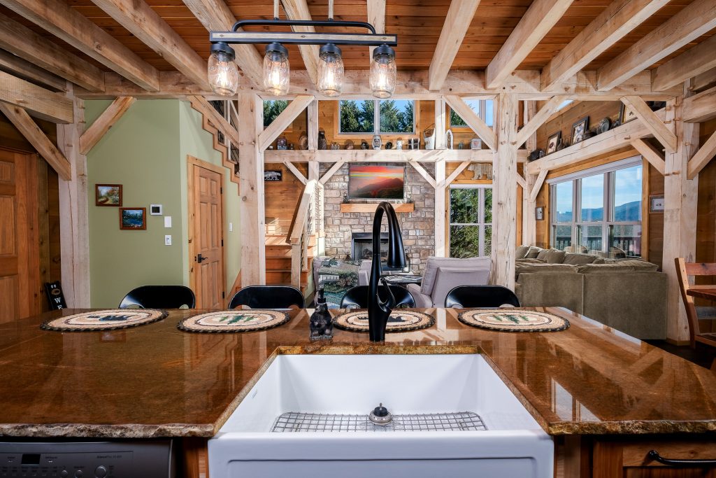 Rustic timber-frame kitchen island set beneath exposed beams in Wears Valley.