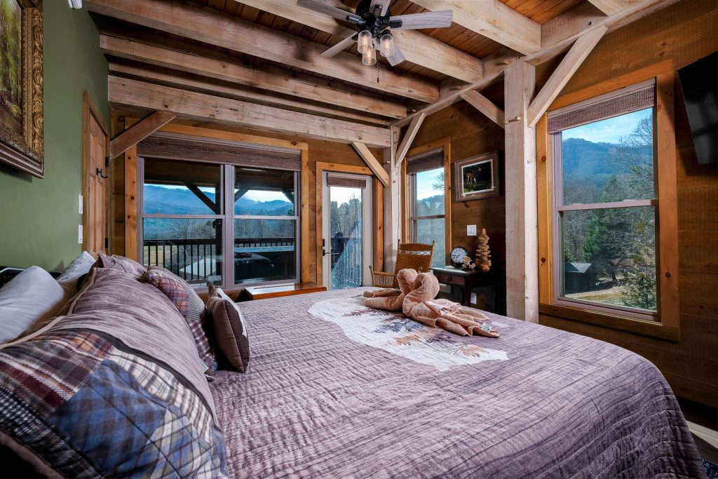 Rustic bedroom opening onto a private mountain-view balcony in Wears Valley.