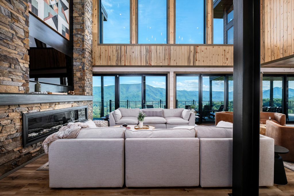 Double-height living room with white sectional at a vacation rental in Wears Valley in the Smoky Mountains.