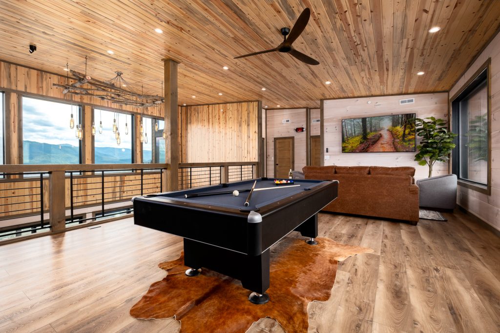 Loft pool table overlooking living room at a vacation rental in Wears Valley in the Smoky Mountains.