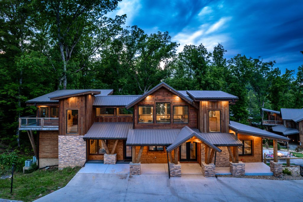 Wood and stone cabin front exterior at a vacation rental in Pigeon Forge, Tennessee.
