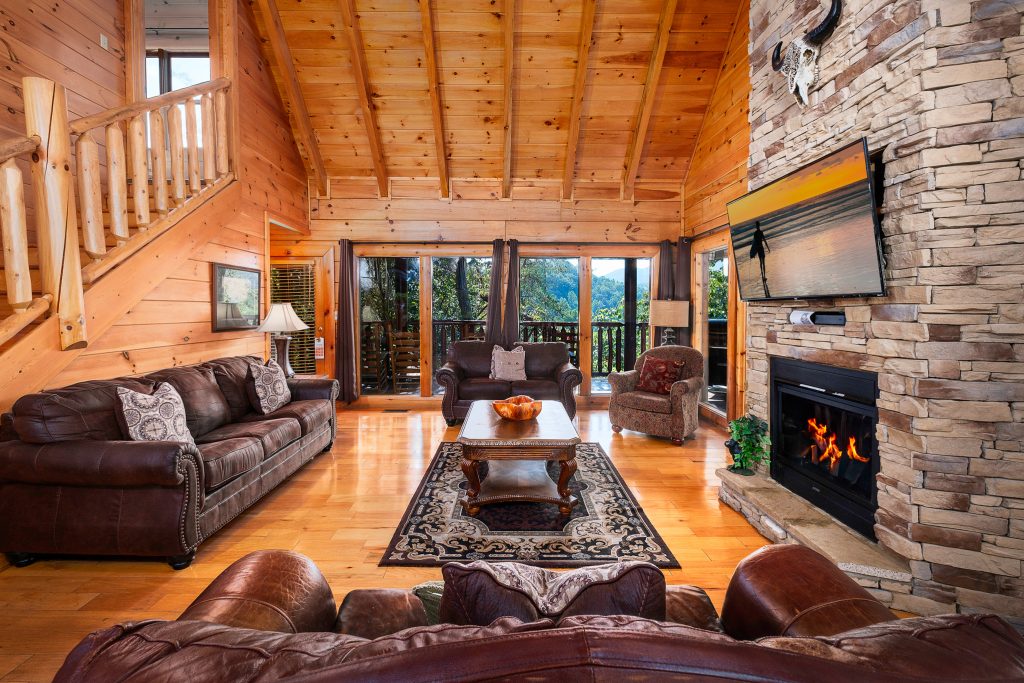 Log cabin living room facing fireplace at a vacation rental in Pigeon Forge, Tennessee.