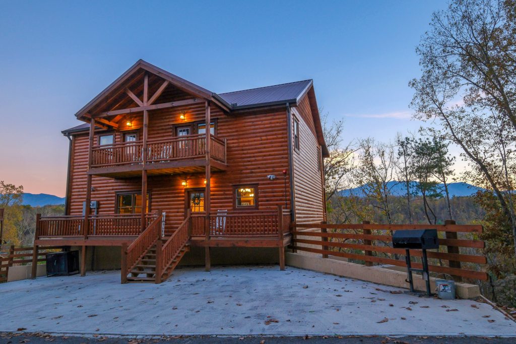 Log cabin exterior at dusk at a vacation rental in Pigeon Forge, Tennessee.