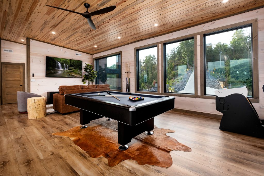 Pool table in modern cabin game room at a vacation rental in Pigeon Forge, Tennessee.