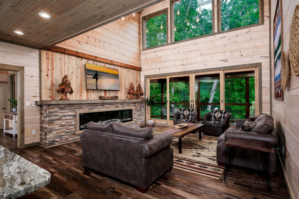 Living room and blue kitchen across granite counter at a vacation rental in Pigeon Forge, Tennessee.