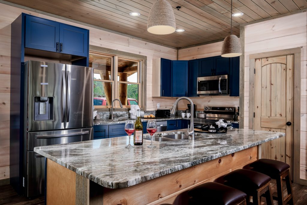 Blue kitchen and granite breakfast bar at a vacation rental in Pigeon Forge, Tennessee.