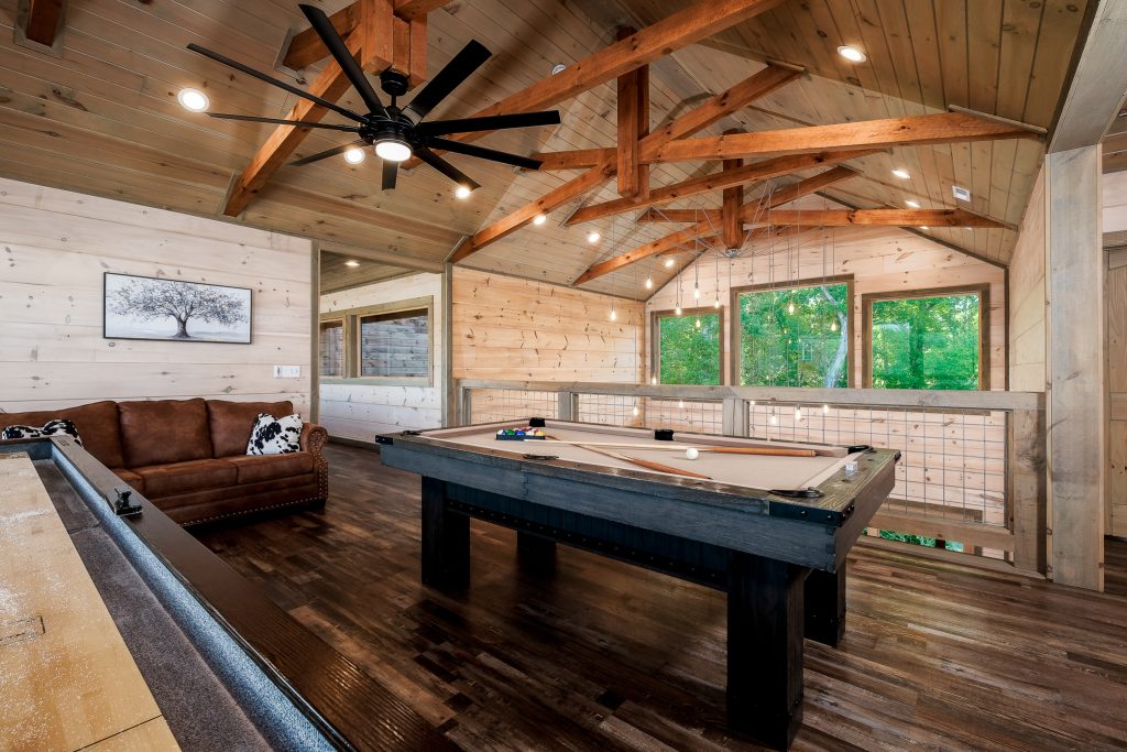 Game room with pool table and shuffleboard at a vacation rental in Pigeon Forge, Tennessee.