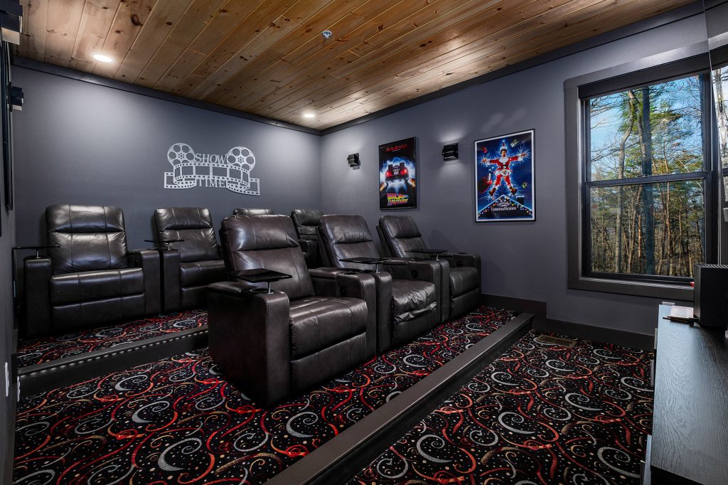 Home theater with reclining seats at a vacation rental in Gatlinburg, Tennessee.