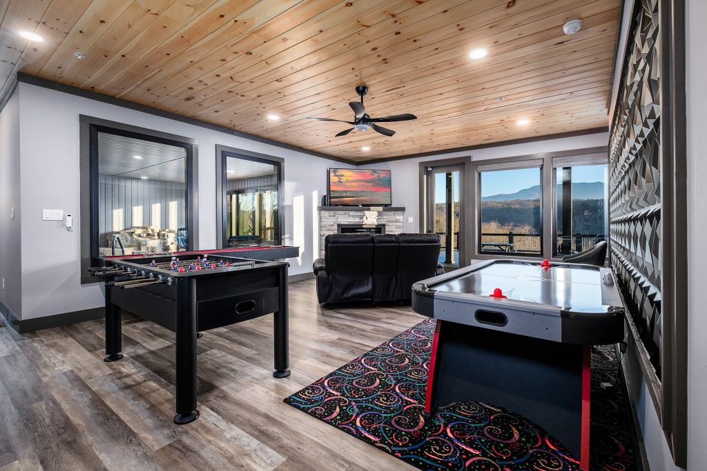 Game room with pool table and air hockey at a vacation rental in Gatlinburg, Tennessee.