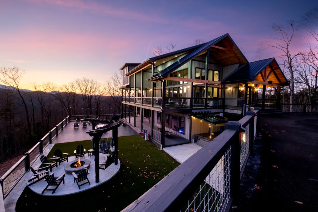 Luxury cabin exterior and putting green at sunset at a vacation rental in Gatlinburg, Tennessee.
