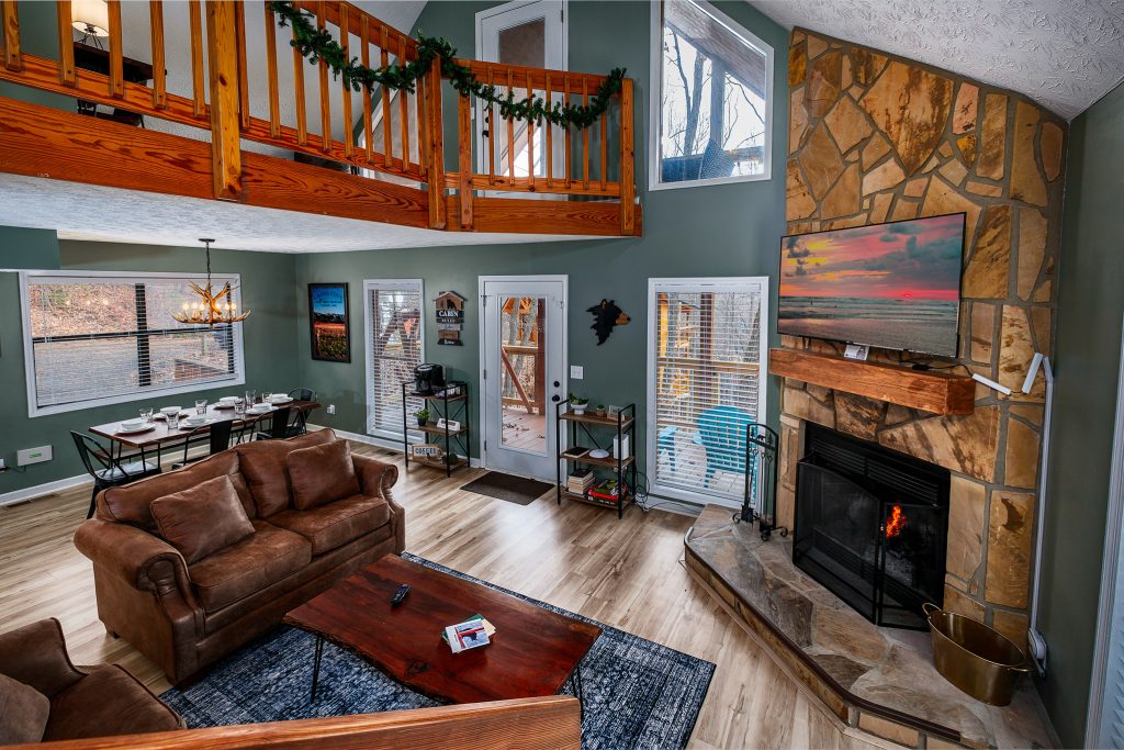 Great room with stone fireplace from loft at a vacation rental in Gatlinburg, Tennessee.