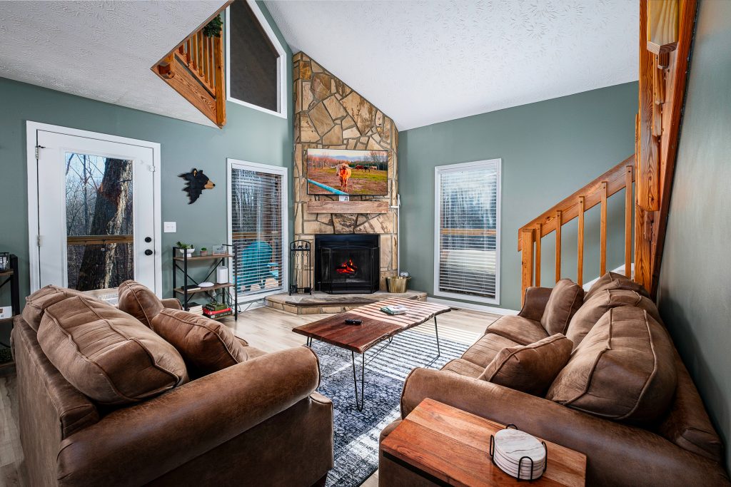 Cabin living room with stone fireplace at a vacation rental in Gatlinburg, Tennessee.