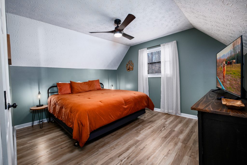 Orange bedroom in mountain cabin at a vacation rental in Gatlinburg, Tennessee.