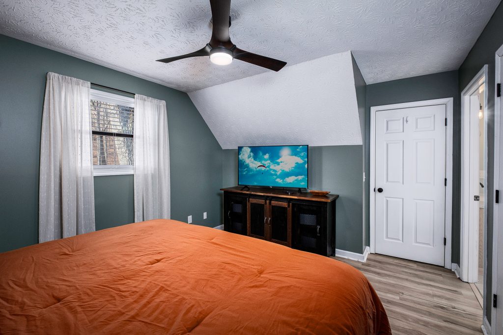 Orange bedroom with vaulted ceiling at a vacation rental in Gatlinburg, Tennessee.