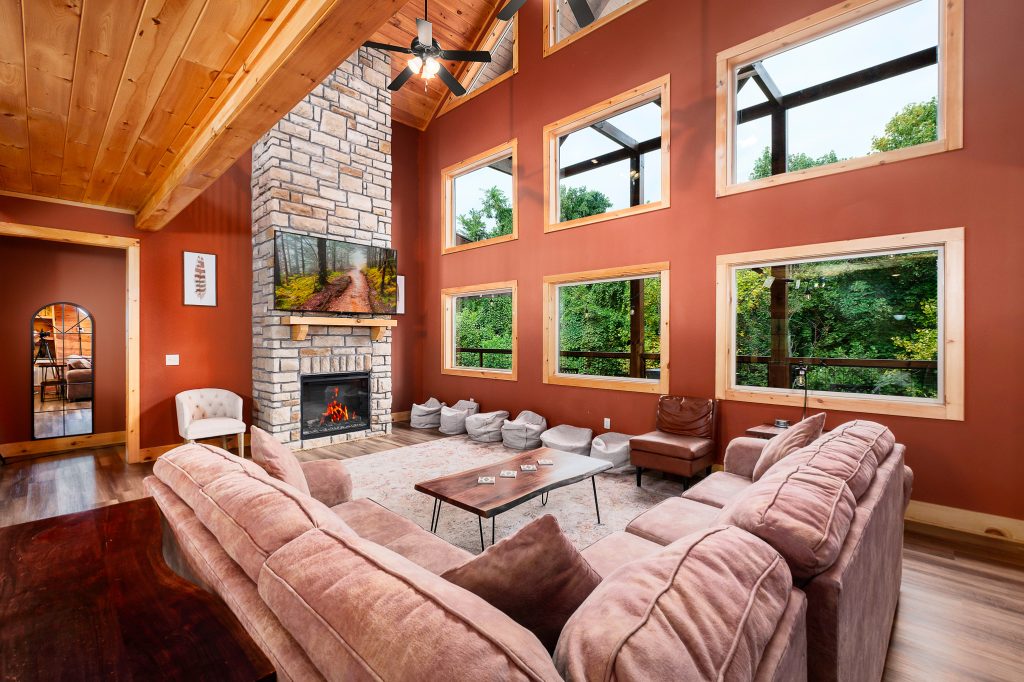 Red great room and stone fireplace at a vacation rental in Gatlinburg, Tennessee.