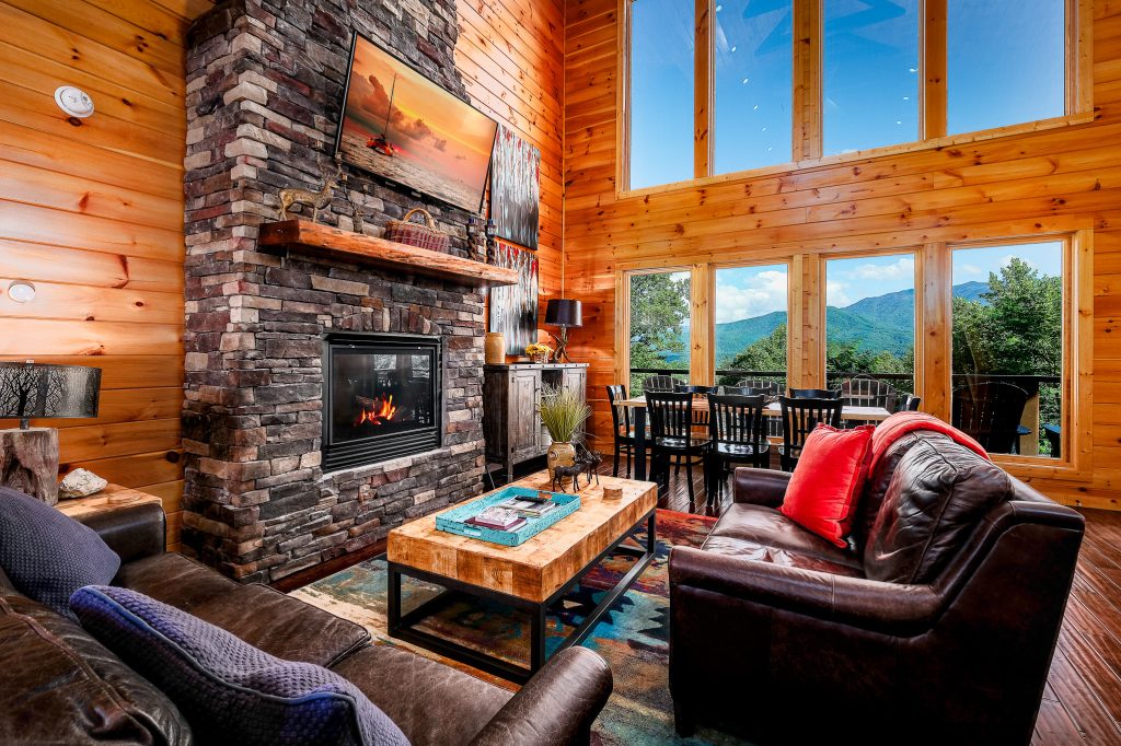 Log great room facing stone fireplace at a vacation rental in Gatlinburg, Tennessee.