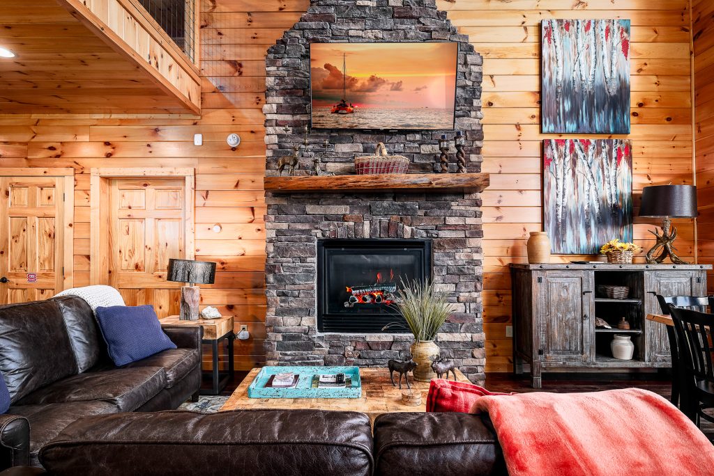 Log cabin fireplace and wet bar at a vacation rental in Gatlinburg, Tennessee.