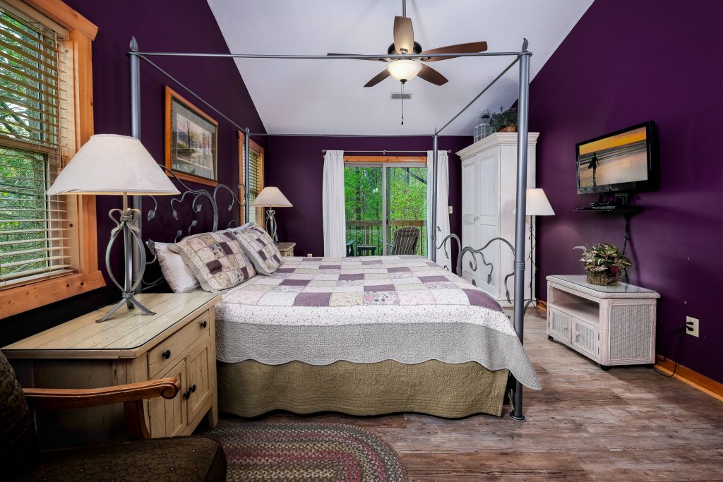 Purple bedroom and private balcony at a vacation rental in Gatlinburg, Tennessee.