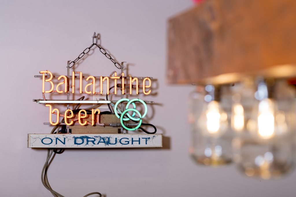 Decorative beer sign photographed inside a Gatlinburg vacation cabin.